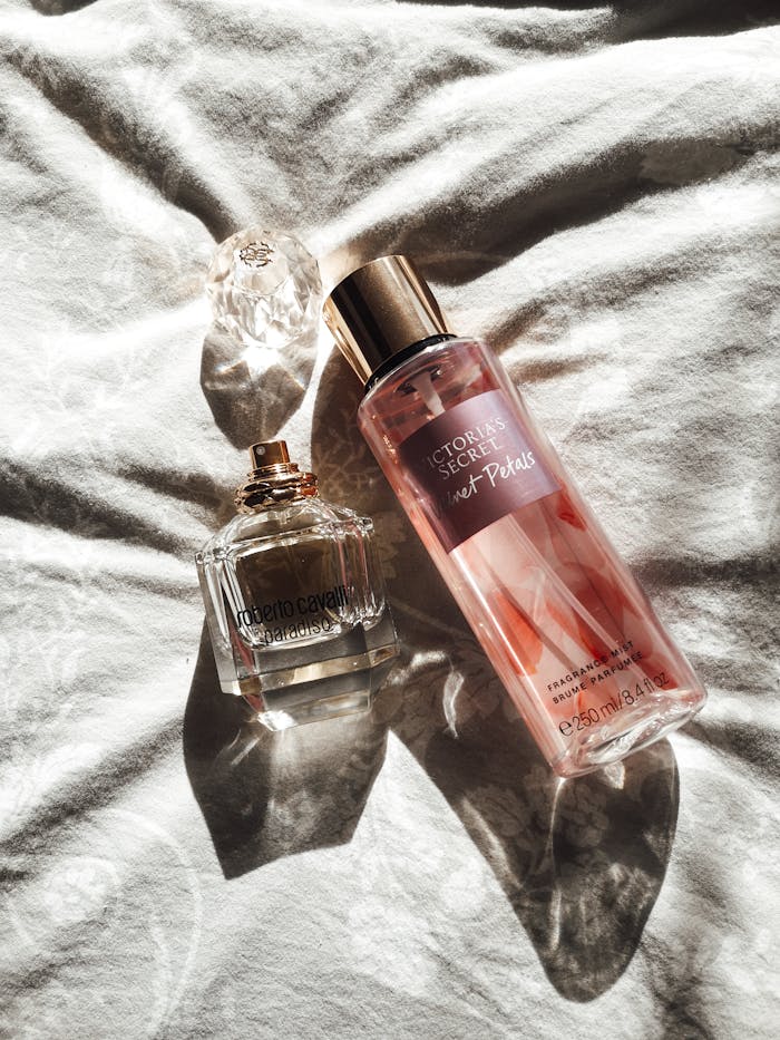 Crafting Captivating Headlines: Your awesome post title goes here A pair of sunlit perfume and fragrance bottles on a soft white surface, creating a serene and luxurious feel.